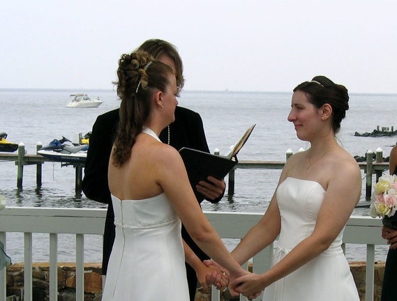 Amy & Liz hold hands during ceremony